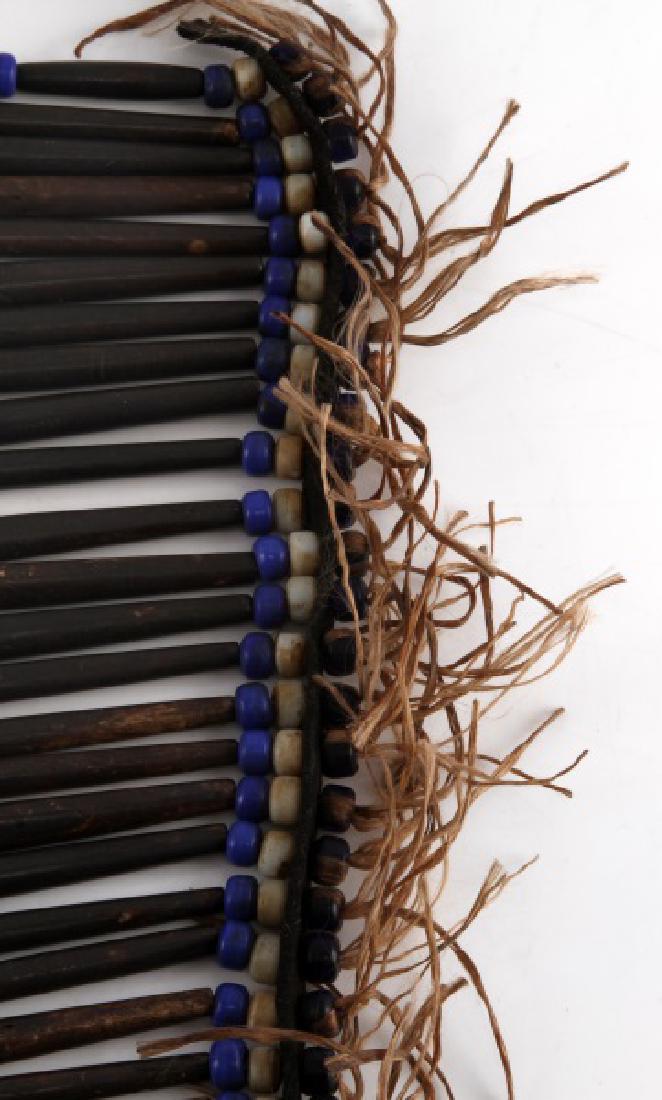 NATIVE AMERICAN BONE PIPE & TRADE BEAD BREASTPLATE: Antique bone piping with blue and white trade bead trim and a arrowhead fetish carved from bone. Measurements are 10 by 13 inch breastplate and 15 by 13 inches total.