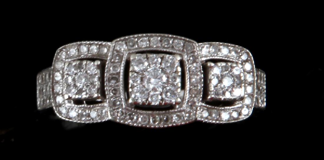 DIAMOND AND 10KT WHITE GOLD WEDDING RING .285 TCW: 3-part square design channel set 10KT white gold wedding ring. Features a round cut center stone measuring 1.5mm and the rest of the round cut surrounding diamonds (over 100) measure between .5 and 1m