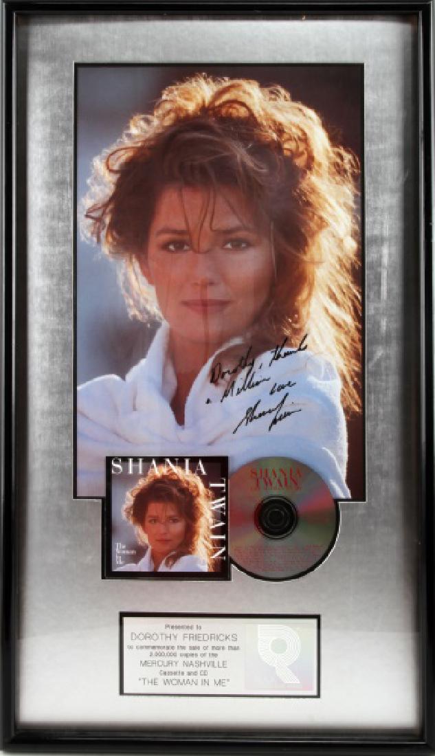 SHANIA TWAIN AUTOGRAPH 2 MILLION COPIES RIAA AWARD: RIAA certified sales award presented to Dorothy Friedricks to commemorate the sale of more than 2,000,000 copies of the Mercury Nashville cassette and CD "The Woman in Me". Framed and matted item incl