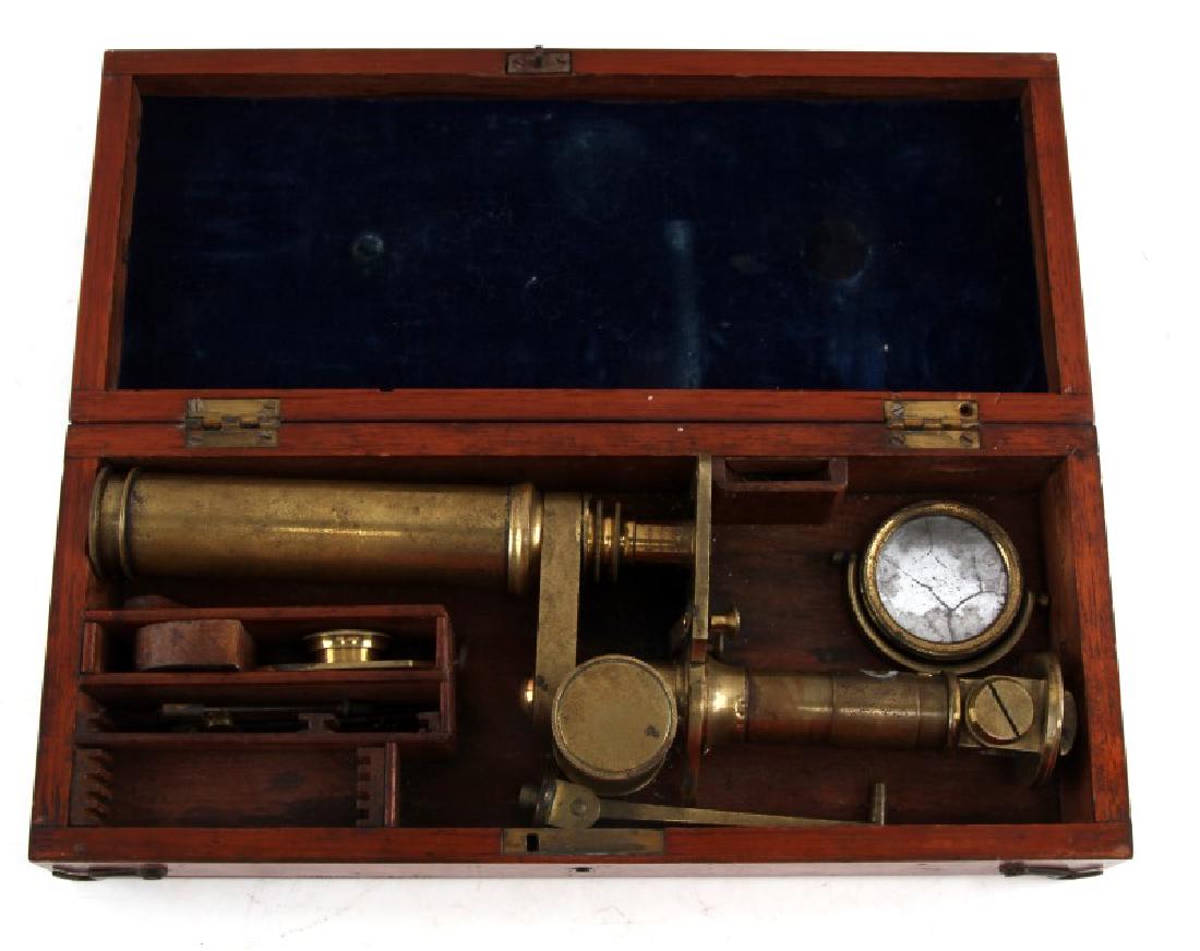 ANTIQUE PORTABLE MICROSCOPE WITH MOUNTING CASE: Brass microscope is stored inside portable wood case and can be mounted to lid for a work surface. Stage clip 1 is missing tip the other has a loss of half of its original length. the Nosepiece has be