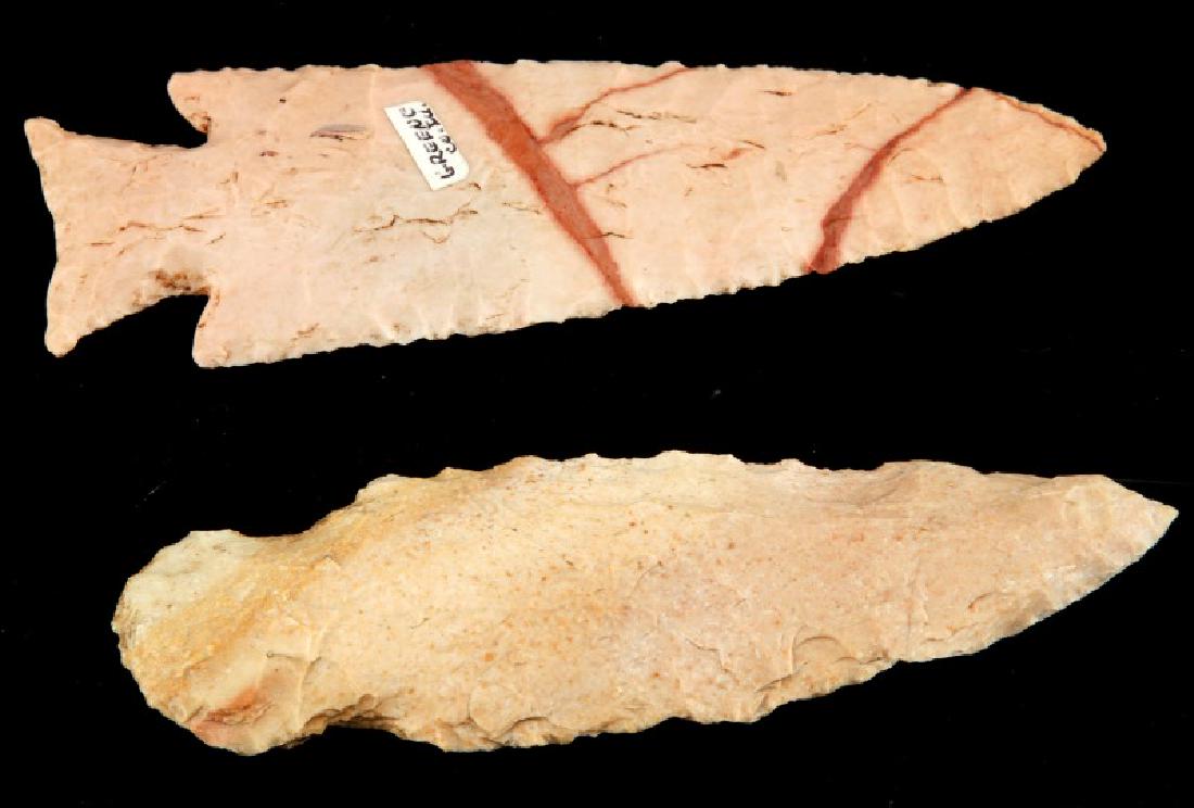 2 ARROWHEAD POINT KNIFE PINK CHERT ILLINOIS: One is made from creamy pink chert with darker inclusion lines, collateral flaking, and ground expanded base, 4.5 inches, Greene County. The second is a rough knife like with broad flaking and more pa