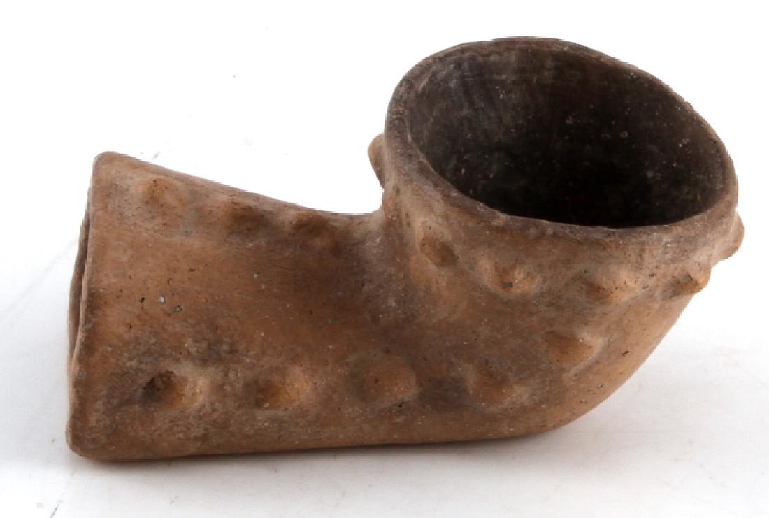 NATIVE AMERICAN ELBOW PIPE CRITTENDEN COUNTY AR: Native American elbow pipe. Taken from Crittenden County Arkansas. Woodland period. Painted clay construction. Wide bowl measuring 2" in diameter. Total length is 3 5/8". Raised bump design encompasse
