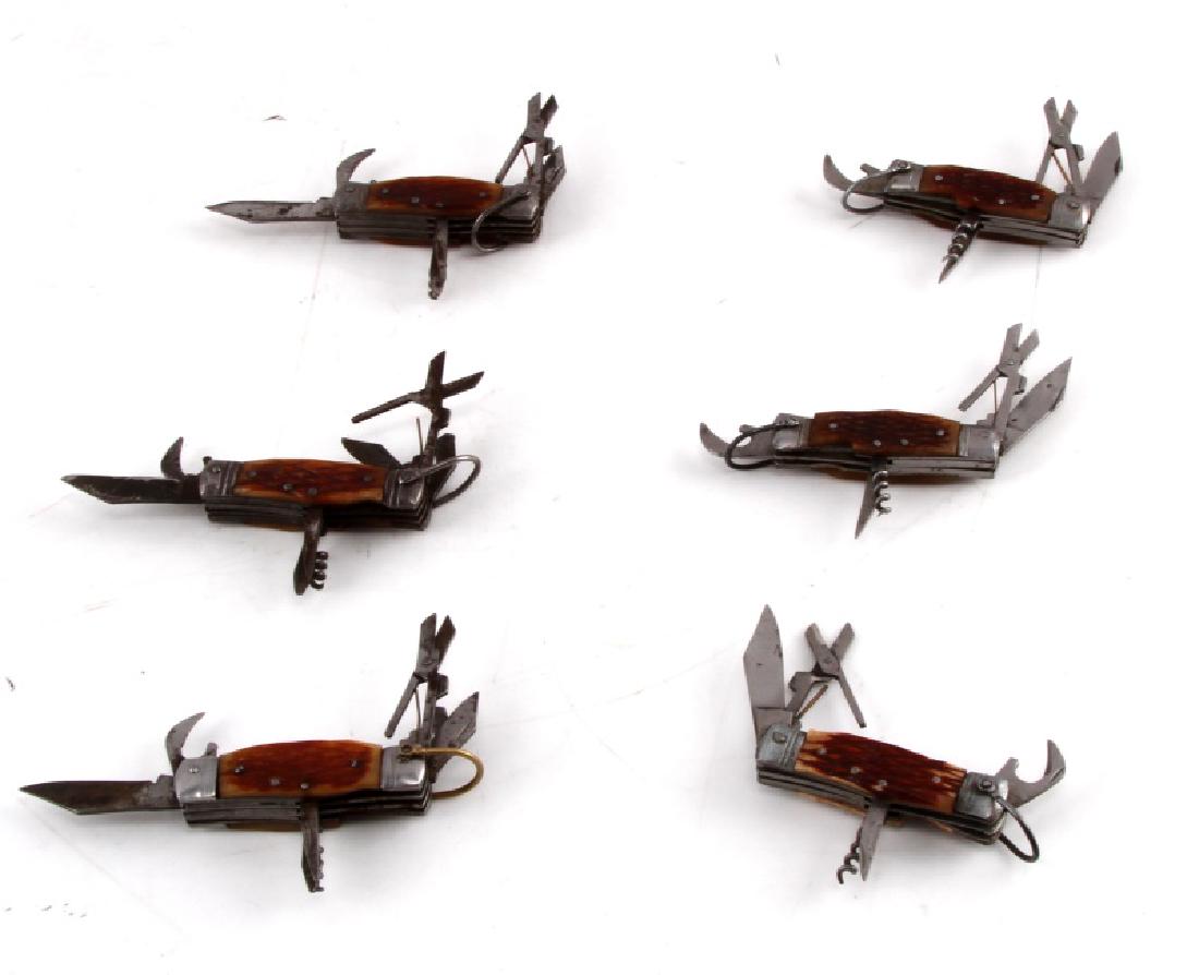 VINTAGE JAPAN MADE POCKET KNIFE LOT OF SIX: Lot contains six copies of the same pocket knife, each of which as a knife, pair of scissors, corkscrew, bottle opener, nail file, and nail cleaner. In fair condition with some corrosion.