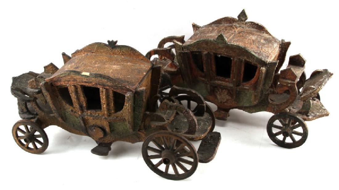 2 VINTAGE OR OLDER WOODEN STAGECOACH MODEL LOT: Lot of TWO (2) vintage or older wooden stagecoach models. Cast iron wheels and axles. Nice detail. Some age wear and a few small areas of chipping present. Top of one stagecoach has come apart at seam