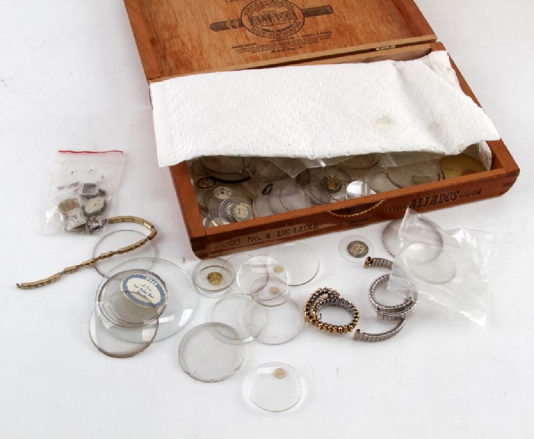VINTAGE WRIST AND POCKET WATCH NEW OLD PARTS LOT: Lot of "new old" excess inventory pocket and wrist watch parts. Includes multiple crystals for both types of watches, several wristwatch movements, and multiple bands and chains.