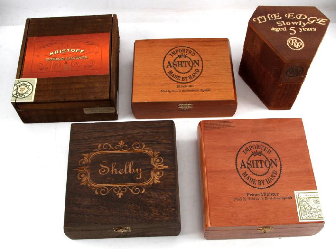 5 WOODEN CIGAR BOX LOT THE EDGE ASHTON KRISTOFF: Lot of FIVE (5) includes: "Shelby" (7.25 x 7 inches), "The Edge" (6 (tall) x 5 inches in diameter), "Kristoff Corojo Limitada" (8.25 x 7.25 inches), larger "Ashton" box (7.5 x 7 inches), and smaller "