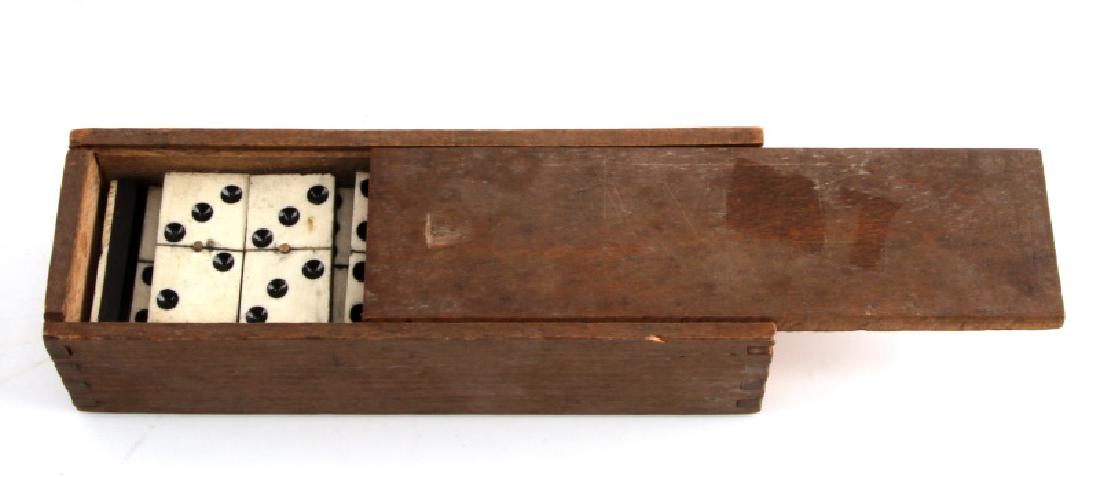 19TH CENTURY CELLULOID & EBONY DOMINO SET COMPLETE: Complete 28-piece domino set with celluloid (bone?) top and ebony wood bottom. Comes in small wooden box. Dimensions: dominos - 1 5/8 x 3/4 inches, wooden box - 6 1/2 x 2 1/8 x 1 3/4 inches. Set is in