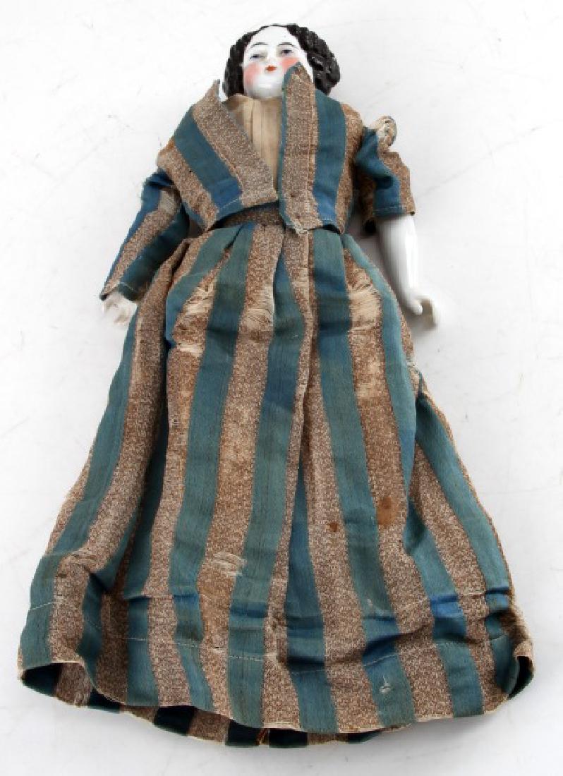 ANTIQUE GERMAN HAND PAINTED PORCELAIN DOLL: Porcelain head, arms, and legs with cloth body. Painted facial features and boots. No markings. Some wear and loss to dress. Overall good condition for age.