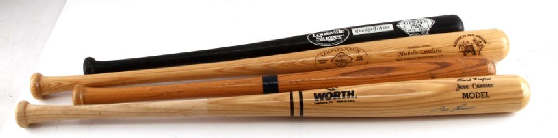 BASEBALL BAT LOT CANSECO COOPERSTOWN LOUISVILLE: First bat measuring 29 inches, carved signature reads "MIKE SCHIMDT", minor wear from usage, in overall very good condition. Second bat measuring 34 inches, hand crafted signed autograph by "Jose Cans