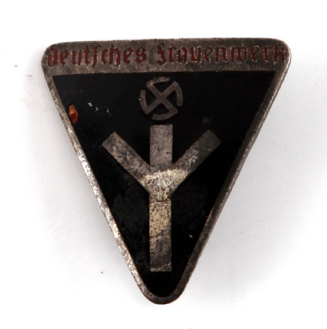 WWII GERMAN WOMENS DEUTSCHE FRAUENWERK BADGE: RZM and M1/102 marked to back. Tarnished, little spot loss to enamel, otherwise good condition.