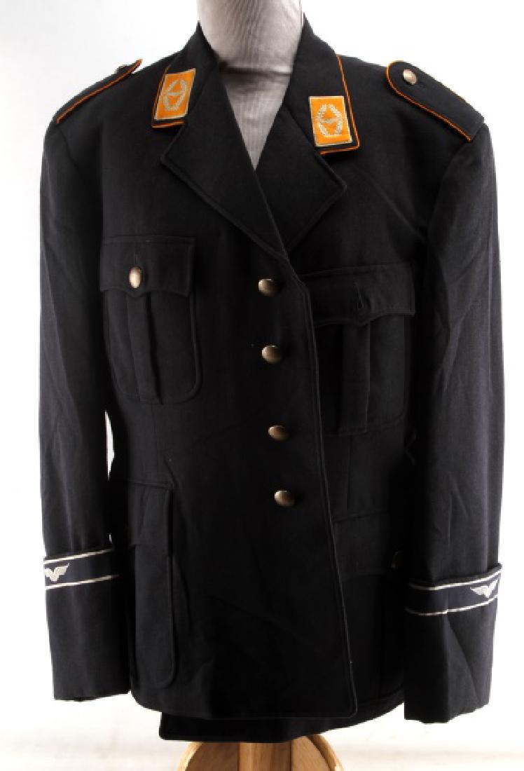 WERNER MAHLBERG POST WAR GERMAN NAVY COAT TUNIC: Blue wool coat with satin interior, yellow piping and collar tabs, blue and white wing armbands, size 23 to inside near hanger. Werner Mahlberg label to left pocket interior. Very good condition. NOL