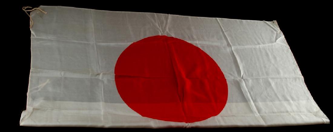 WWII JAPANESE IMPERIAL NATIONAL FLAG SILK MEATBALL: WWII Japanese military silk meatball flag with a central rising sun and a folded hemmed border, and leather corner fittings connected to the flag ties for fastening. Flag measures 26.5 inches by 39 in