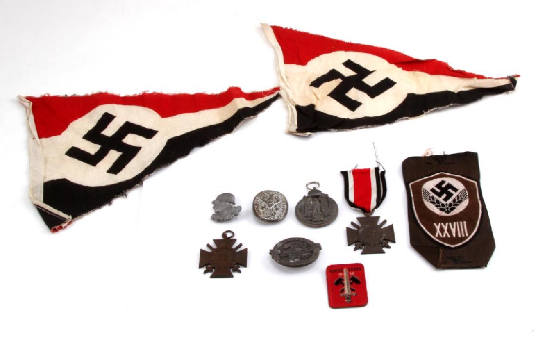 LOT OF GERMAN WWII PENNANTS TINNIES MEDALS MORE: Lot of German WWII items. Includes 2 Swastika pennants (fraying on edges), 4 tinnies, Eastern Front medal, 2 Honour Cross of the World War 1914/1918, and one patch. Unauthenticated, sold as is.