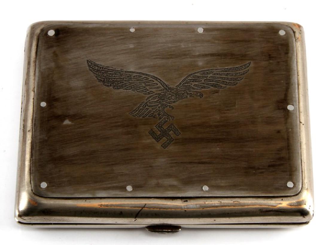 GERMAN WWII LUFTWAFFE PILOTS CIGARETTE CASE: Measures approx. 4 1/4 x 3 3/8 inches. Inside leather liner and elastic straps are intact. Very good condition overall. Unauthenticated. Sold "as is". This lot has a reserve.