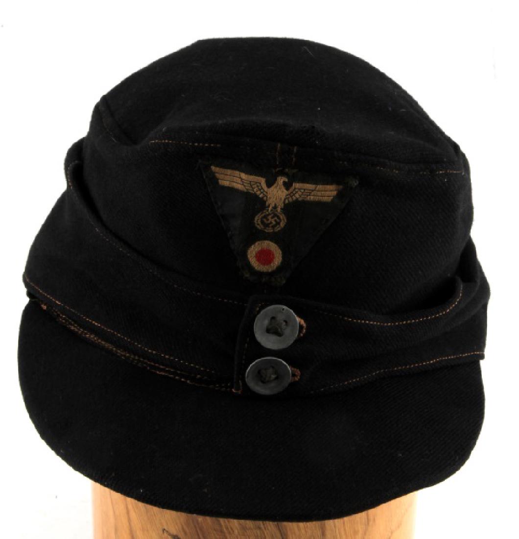 WWII GERMAN THIRD REICH BLACK WOOL M43 FIELD CAP: M43 field cap made of black wool. Has triangular patch with Reichsadler and roundel on the front. In very good condition, does not fluoresce under blacklight, has a small hole on the top of the hat ne