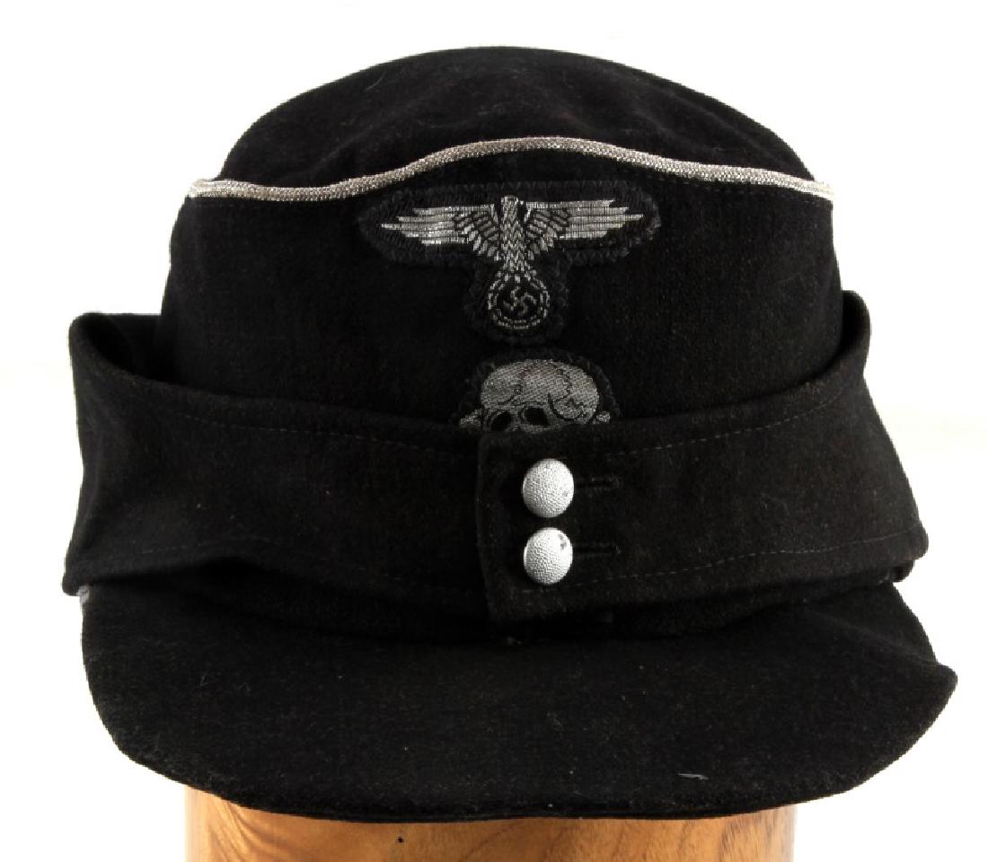 WWII GERMAN THIRD REICH SS PANZER OFFICER M 43 CAP: Black SS panzer officer M-43 field cap. Has silver bullion wire around top of cap. Bullion wire Totenkopf and Reichsadler patches. In very good condition. Does not fluoresce under blacklight. Size 58 