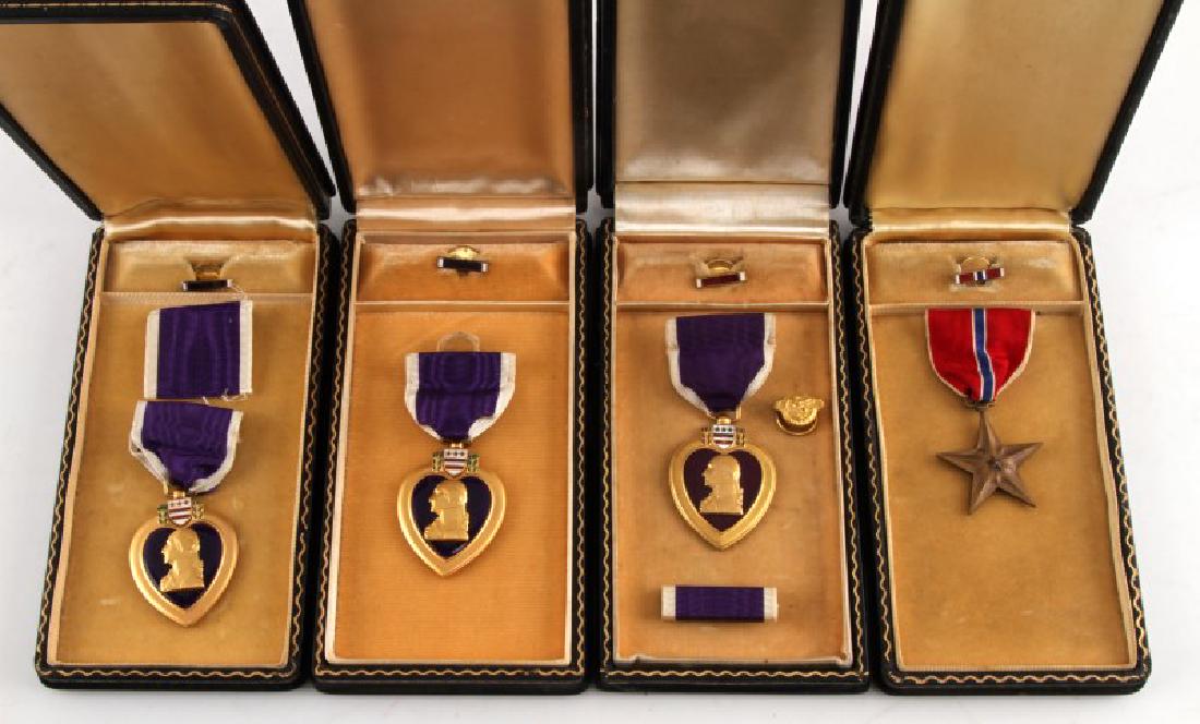 3 PURPLE HEART & 1 BRONZE STAR UNNAMED MEDAL LOT: All in original black coffin cases. All lapel pins included. Three of the ribbon bars are missing. All in good condition with some expected age wear.