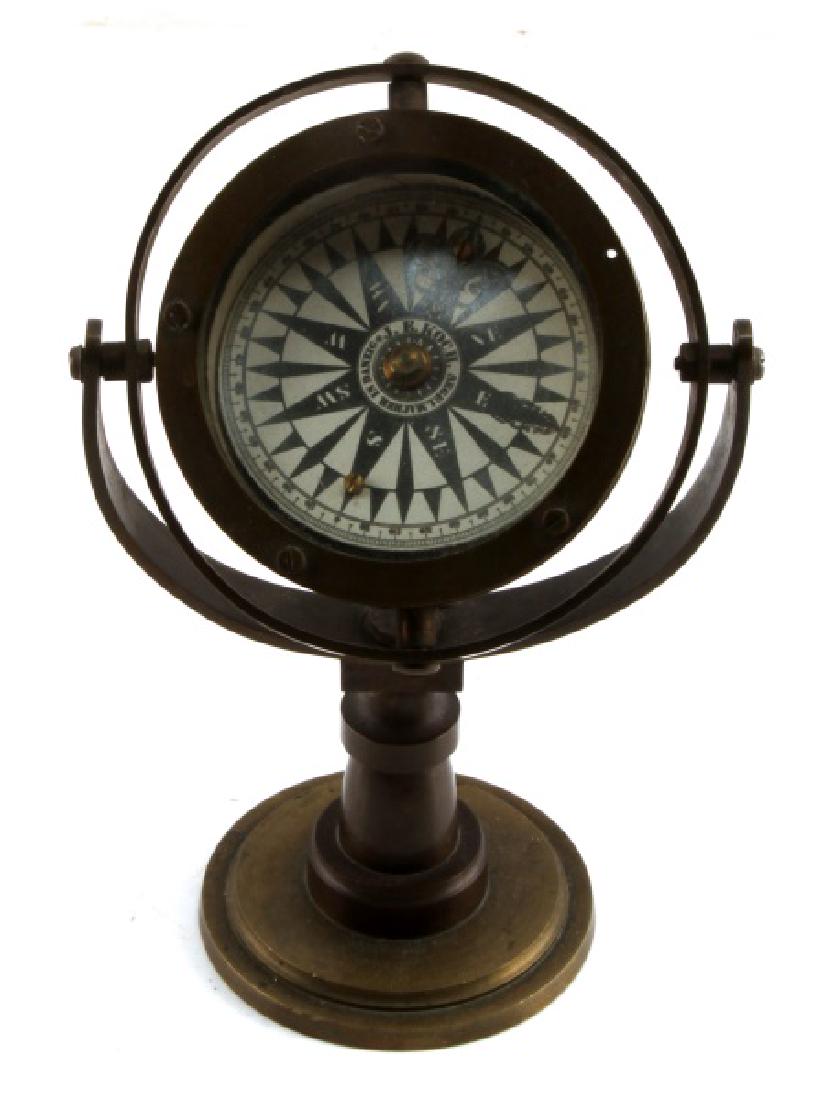 BRASS J E KOCH SEGELMACHER IN DANZIG TABLE COMPASS: Stands 8.5 inches. Some tarnish and verdigris present. No maker's marks.