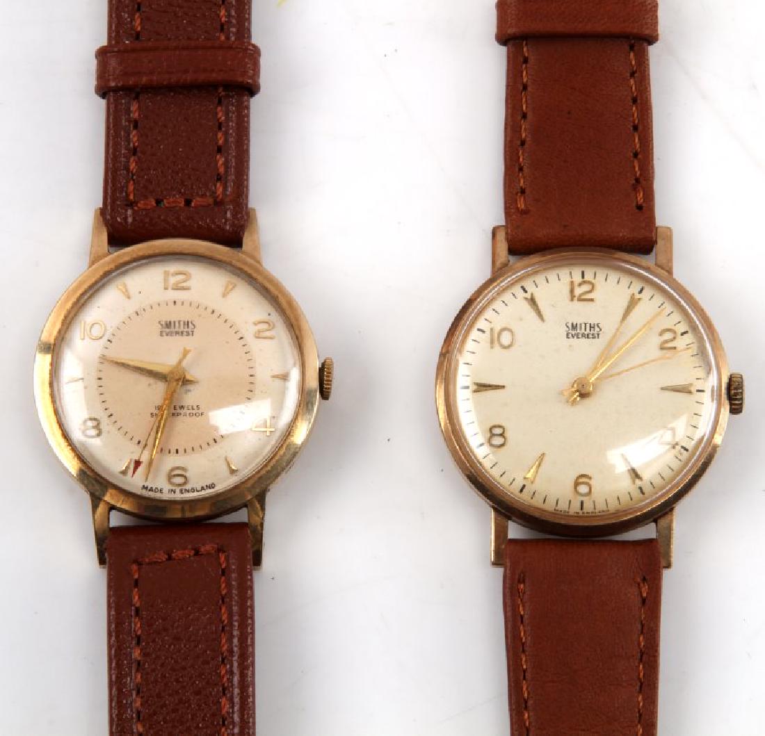 SMITH EVEREST GENTLEMAN GOLD PLATED WATCH LOT: Lot contains two Smith Everest watches. The first appears to be a retirement watch, based on the engraving upon the reverse, and the wristband is made of fine leather. The watch runs and is in very go