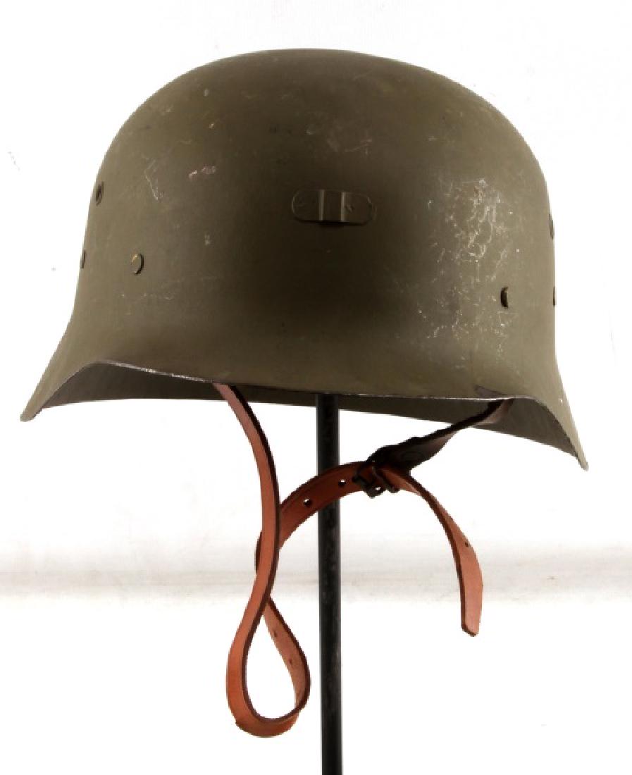 SPANISH POST WAR STEEL HELMET W LINER MODEL Z: Spanish post-war steel M42 helmet (Model Z). Light paint loss and wear present. Leather liner intact. Two of the 3 interior liner flaps bear hand written text that is non-legible. Chin strap is a repl