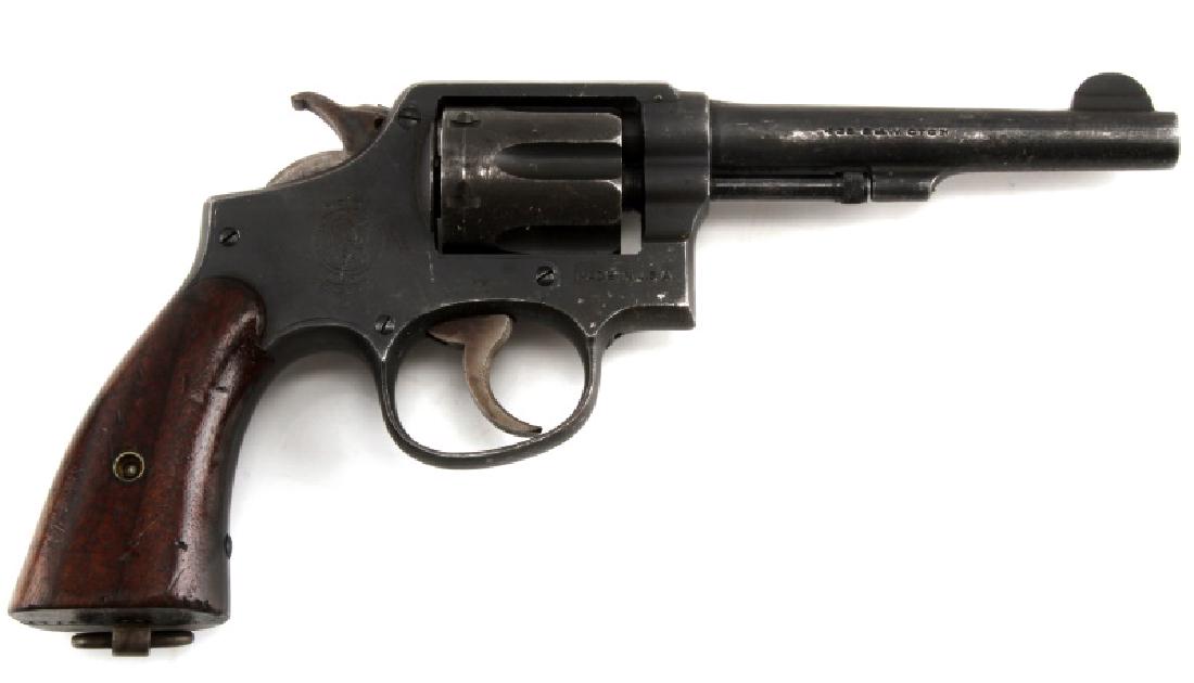 VINTAGE SMITH AND WESSON .38 CAL REVOLVER: A vintage Smith and Wesson double-action revolver, .38 cal.. Bore is bright and clean. In very good condition with minor wear to the bluing of the steel. Barrel measures 4 3/4 inches in length. Cannot