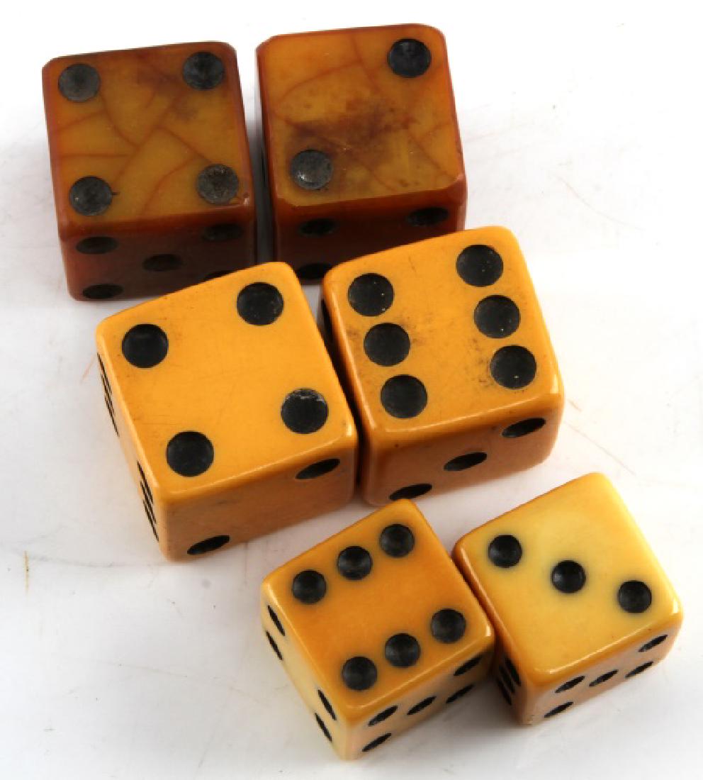 3 PAIR ANTIQUE AMERICAN BAKELITE GAMBLING DICE LOT: Rare lot of 3 pair (6 pieces total). Antique dice have normal wear/tear and discoloring. Two pair are bone colored, one pair is butterscotch colored. Pairs measure: 1 1/4 inches, 1 3/8 inches, and 1 1