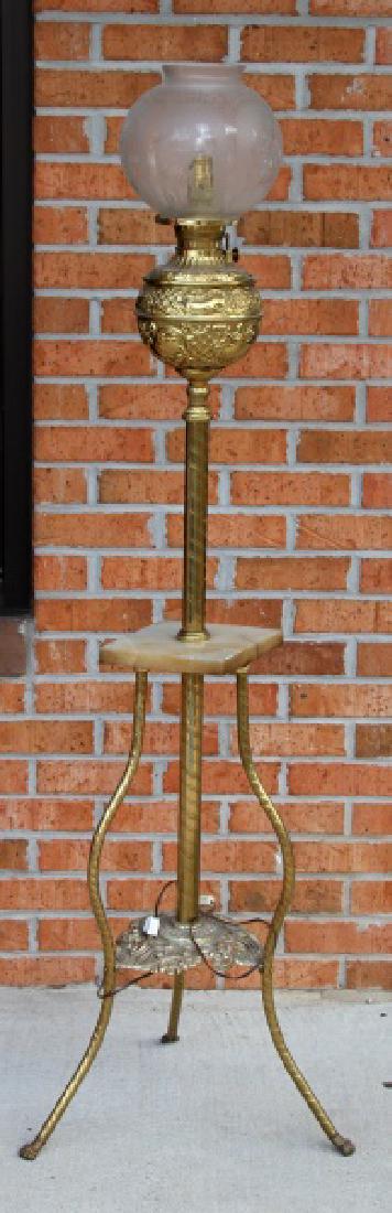 BRADLEY & HUBBAR VICTORIAN PARLOR PIANO FLOOR LAMP: Converted from oil to electric gilt tripod floor lamp measuring 60 inches in height, 18 inches between claw foot legs. B & H marked. Light chipping on marble. Globe has 9 inch diameter and is fragile.