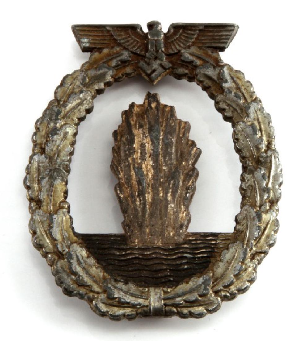 WWII GERMAN THIRD REICH MIND SWEEPER BADGE: Shows heavy signs of age and discoloration. The vertical pin is missing. The reverse is marked Fec. Otto Placzek Berlin Ausf. Schkein