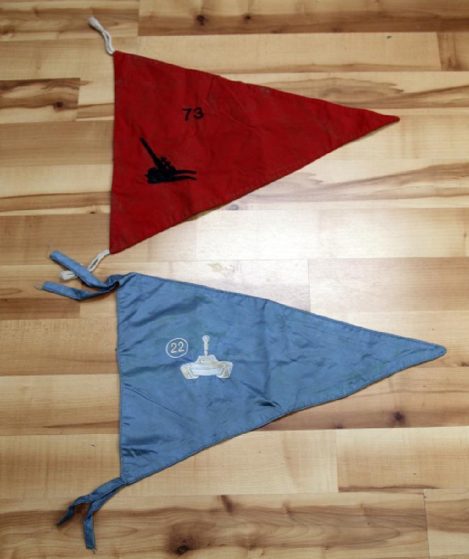 VIETNAM WAR US ARMY UNIT PENNANT FLAG LOT OF TWO: Lot contains two pennant flags from the US Army in the Vietnam era. One is a red flag with an embroidered artillery gun with the number '73' next to it. The other is a blue flag with an embroidered ta