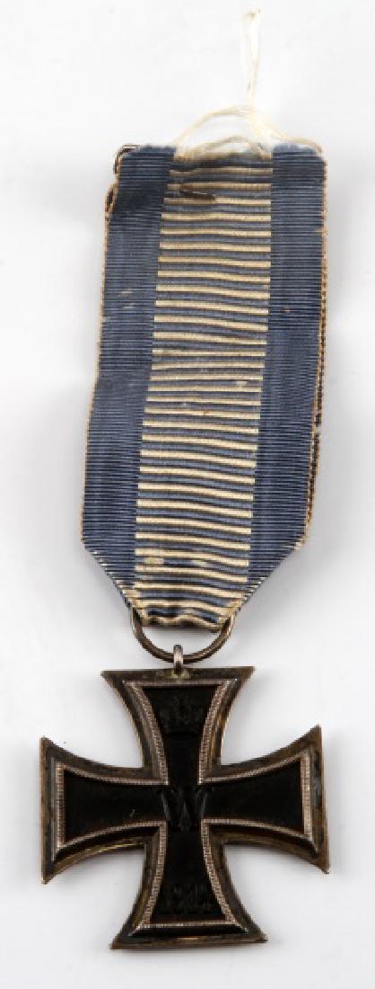 WWI IMPERIAL GERMAN SECOND REICH IRON CROSS MEDAL: An Iron Cross, Second Class medal from World War I. Magnetic core and tests for silver content. In very good condition with minor tarnish. Has an unknown blue and white ribbon attached.