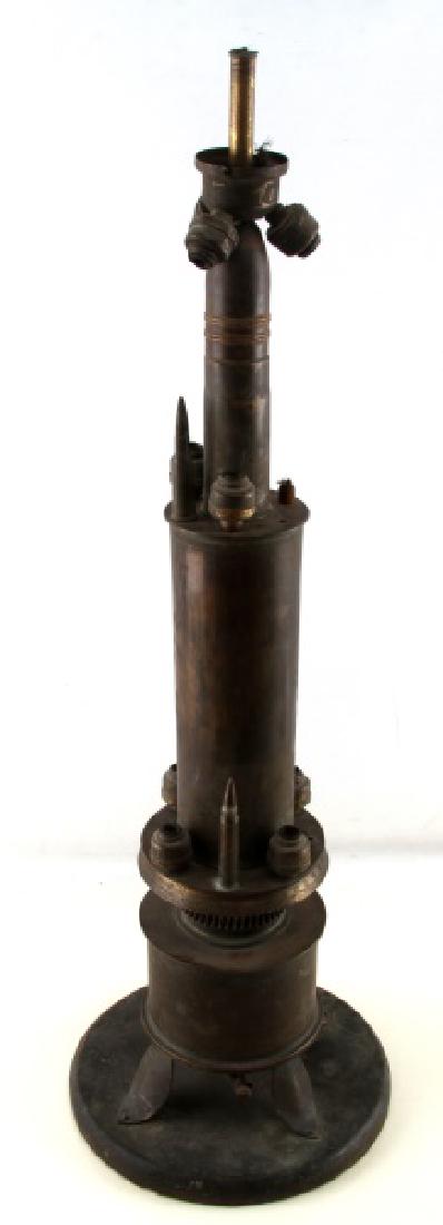 ANTIQUE TRENCH ART LAMP MADE FROM SHELL CASINGS: Measures 29 inches tall. Made from various size rounds. Does not have a power cord attached.