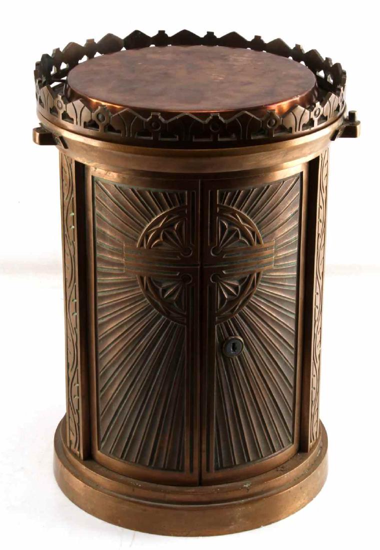 ANTIQUE CATHOLIC BRASS ALTAR RELIQUARY: Catholic altar reliquary made of brass. Cylindrical in shape. Doors on the front are locked and key is missing. However, top of reliquary can be removed and reveals an unknown item wrapped in cloth in