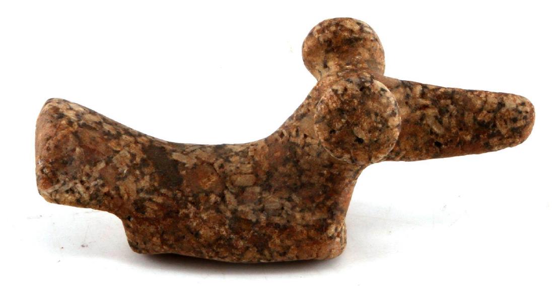 NATIVE AMERICAN CARVED POPEYE BIRDSTONE: Popeye birdstone. Measures 4 1/2 inches in length and 2 inches in height. Has two holes carved in the base running to the front and back.