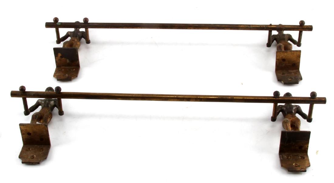 ANTIQUE BLACK AMERICANA MALE FIGURAL BRASS RACK: Metal towel rack with brass finish, use wear evident, measuring 18x6x2 inches features male figure wall mounts. The figure is missing the knob that extends past the rod he is holding up, this loss doe