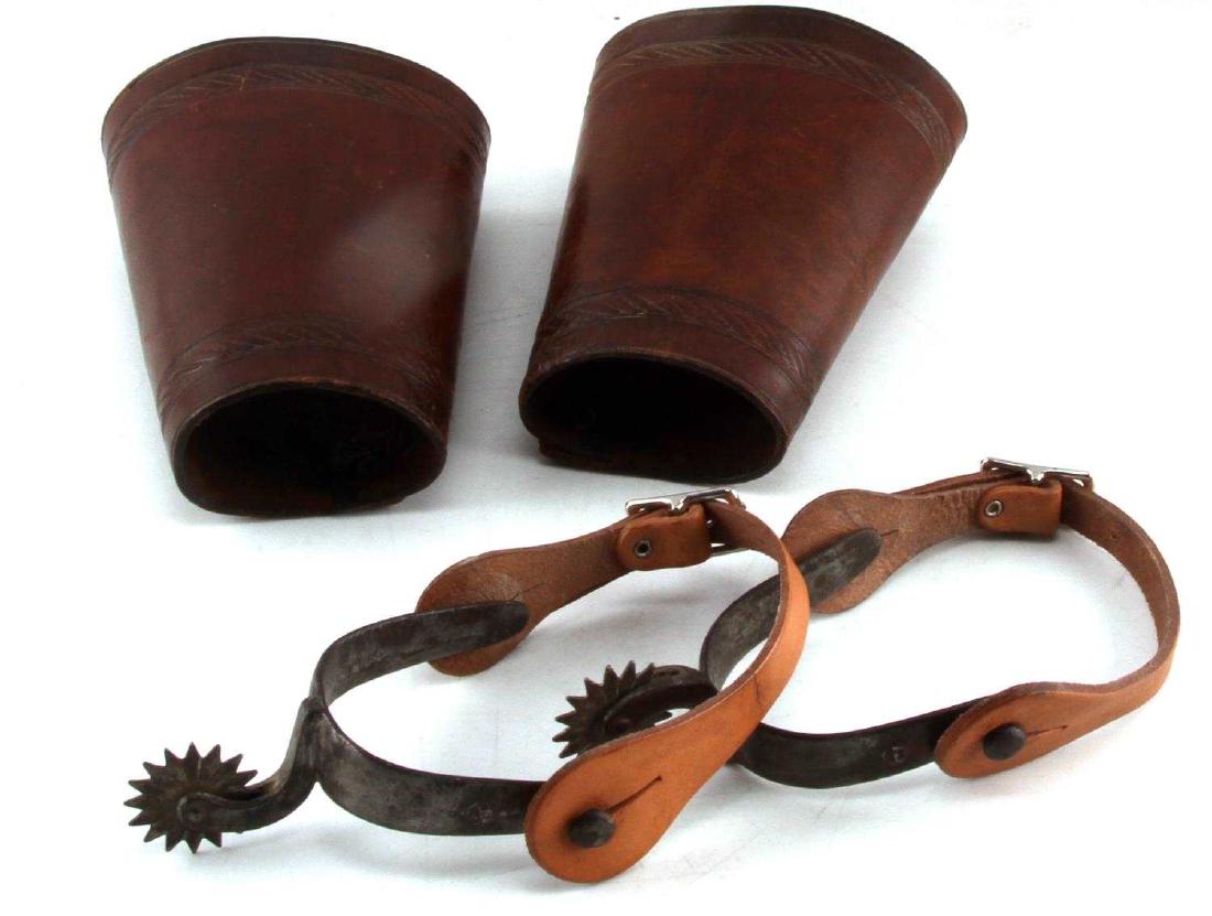 ANTIQUE WESTERN COWBOY CUFFS & BEURMANN SPURS: Measurements: 7 inches in length, with 4 inch and 3 inch diameters. Interior snaps read Feb. 1903. In good condition with minor scuffs and use wear. August Buermann Western Spurs, hand forged steel co