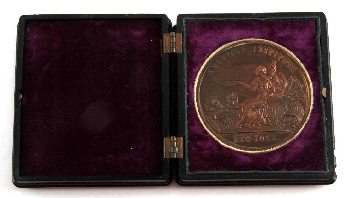 AMERICAN INSTITUTE OF NY BRONZE MEDAL OF MERIT: Awarded to Samuel Halls Son & Co. (1865) for "fine specimens of screws, bolts, nuts, washers, etc.". Approx. 2.25 inches in diameter. Nice patina. In original case. Latch doesn't keep case closed and 