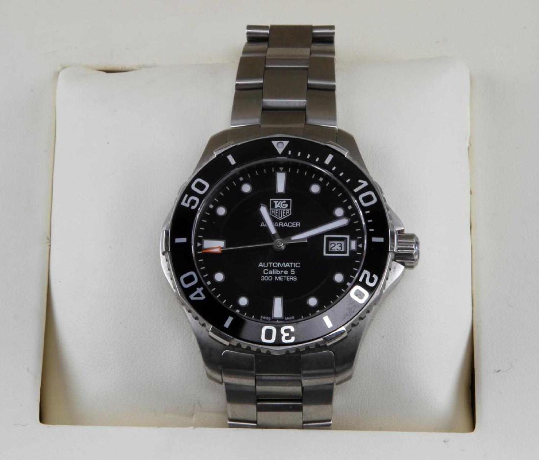 TAG HEUER AQUARACER MENS SWISS WATCH: A Swiss Men's Tag Heuer Aquaracer watch. Has 30mm bezel. Automatic movement, third hand, and date. Includes two extra links. In original box with booklet. Very good condition, minor scuff marks on som