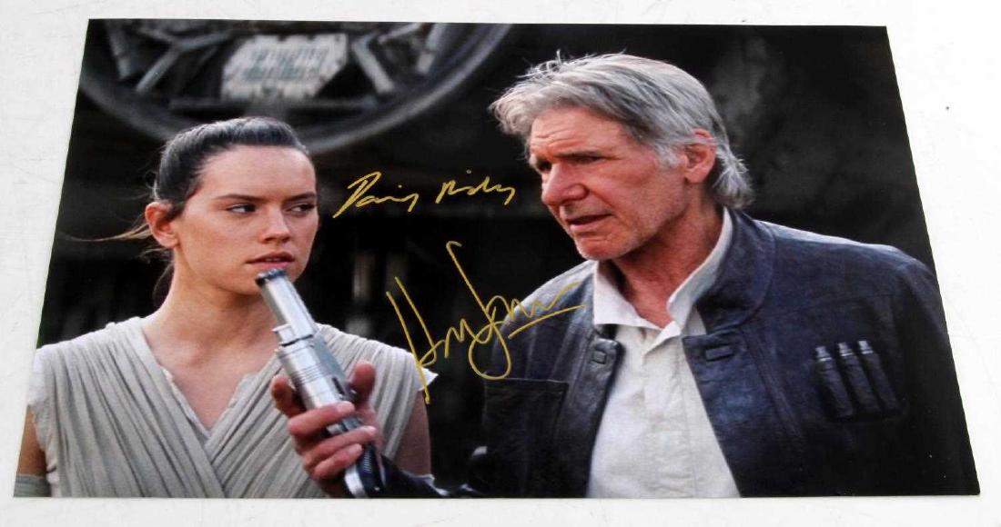 HARRISON FORD & DAISY RIDLEY STAR WARS AUTOGRAPH: Color photo from Star Wars VII measures 12 1/2 inches by 8 inches. Double signature. Has COA from VIP #4091982
