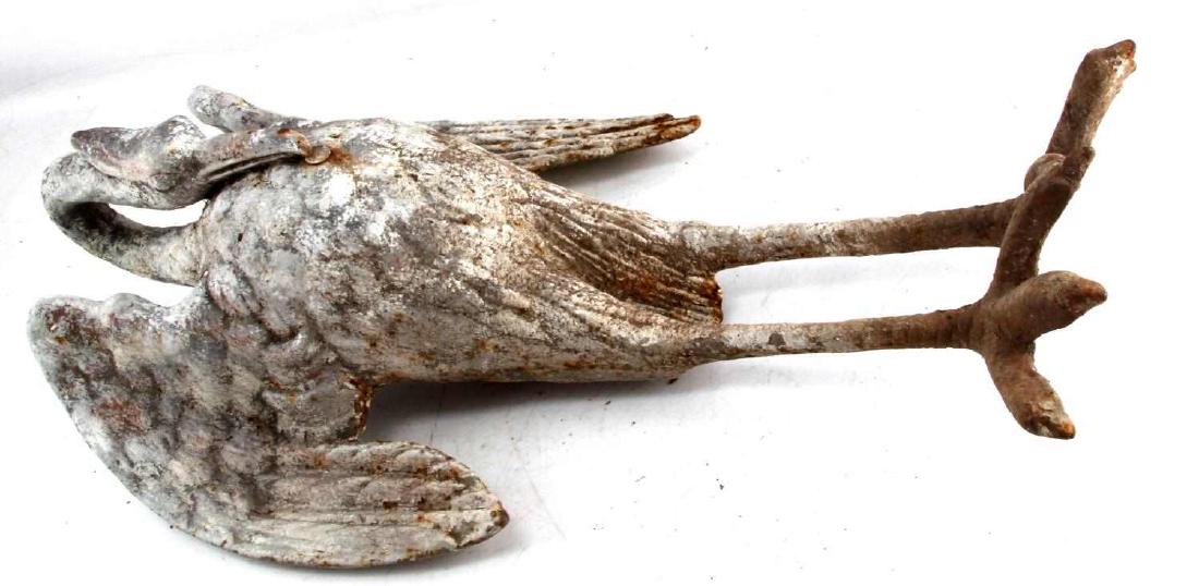 ANTIQUE IRON HERON SCULPTURE WALL HANGER: Antique iron harron sculpture. Original white paint has heavy fading accompanied with oxidation. G condition. Measures approx. 26" in height.
