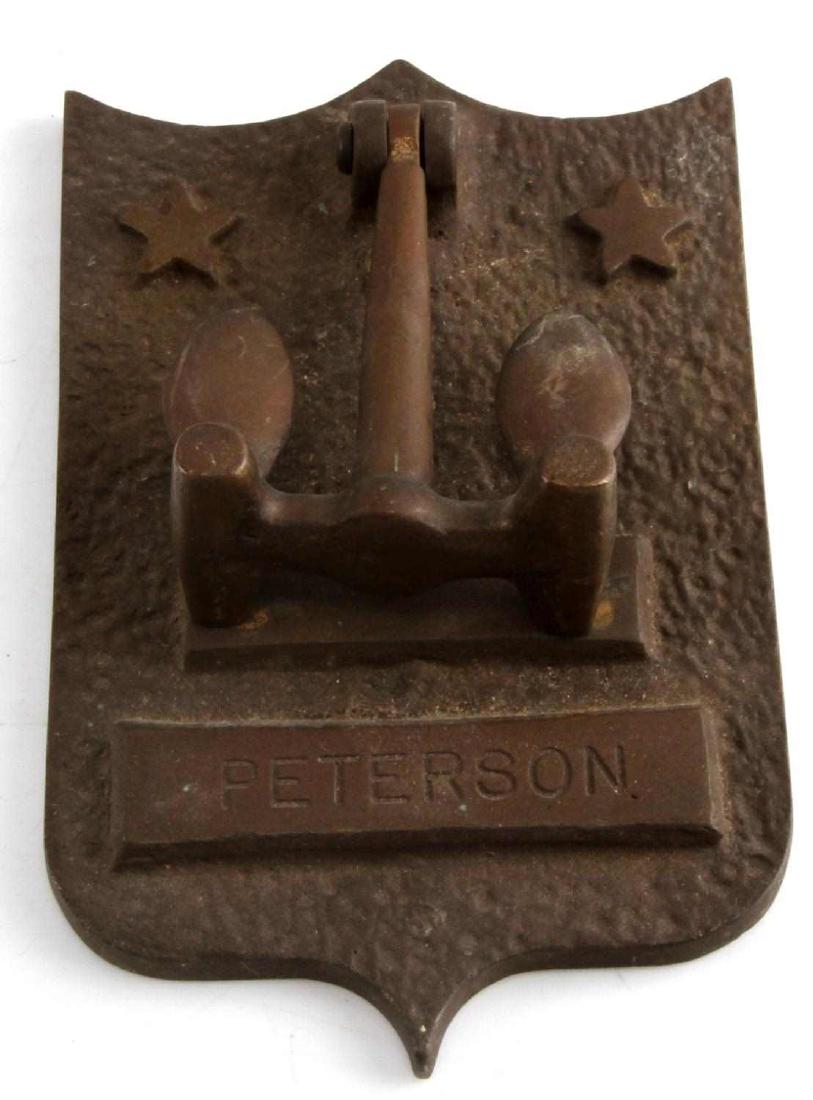 U.S NAVY NAVAL OFFICERS BRASS ANCHOR DOOR KNOCKER: United States Naval Officers Brass Anchor door knocker named "PETERSON" with a central anchor as the knocker with 2 five-pointed stars on each side of the central anchor. Measures 4 inches wide by 6 i