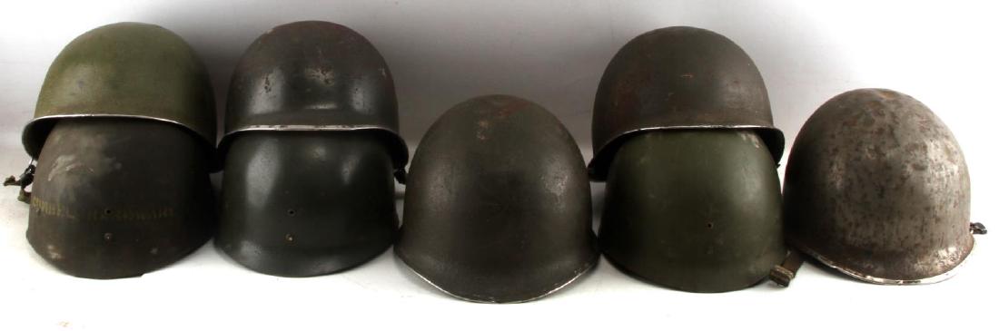 5 US WWII M1 SWIVEL BALE HELMETS WITH LINERS: 5 US M1 swivel bale helmets, 3 of which have liners. G-VG condition. One shows a repainted interior. All show fading on the paint and expected wear marks from use.