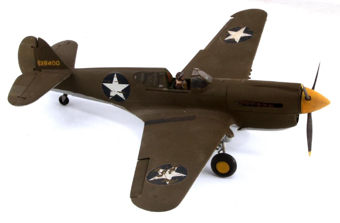 US ARMY AIR FORCE CURTISS P-40 WARHAWK MODEL PLANE: A 12 1/2 in length plastic model of a P-40 Warhawk. In good condition, with some wear on the star stickers. The right aileron and right engine exhaust have come loose and need to be reattached. No can