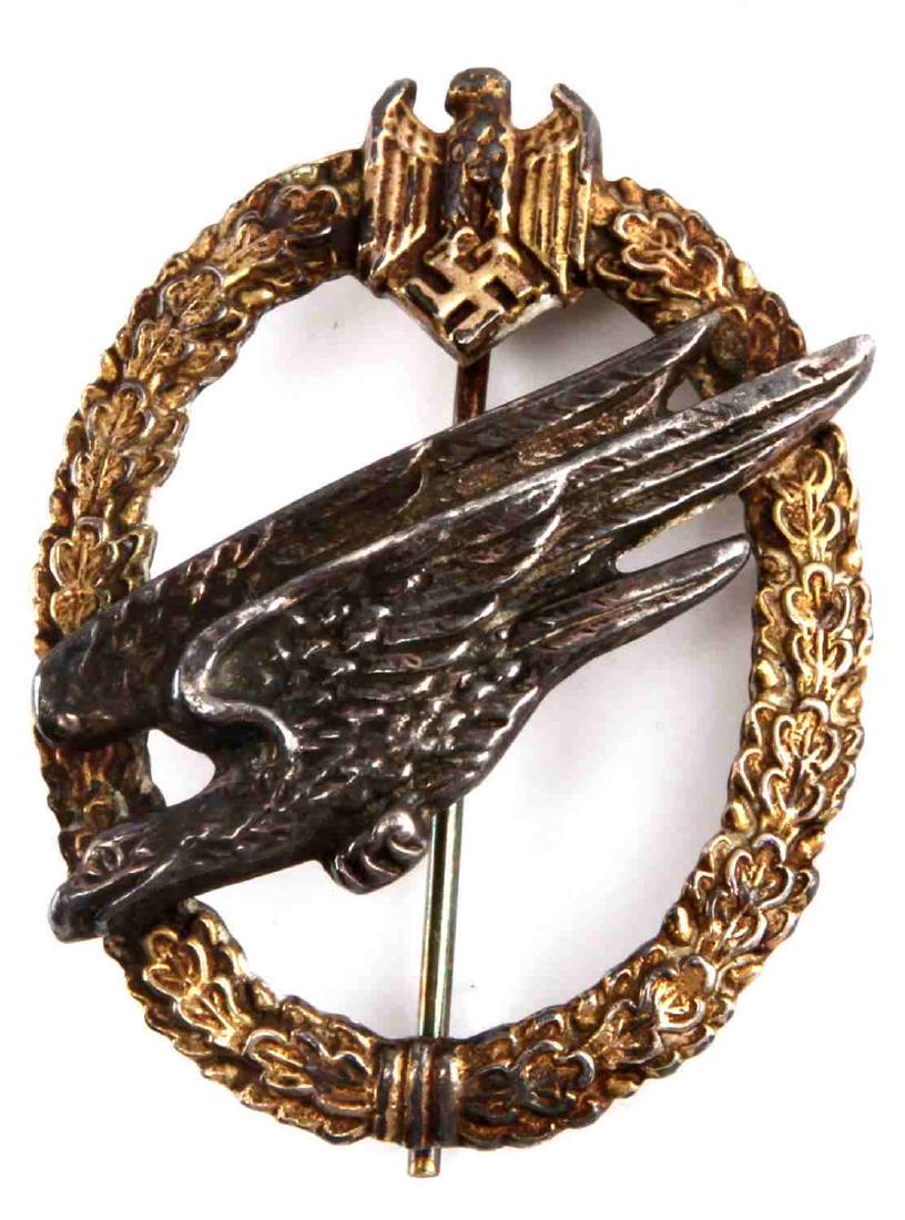 WWII GERMAN THIRD REICH PARATROOPER BADGE: A German Fallschirmjaeger badge. Thin stick pin clasp. Marked 'GE Junker Berlin SW' on the back. Good condition. Unauthenticated/Sold 'as is'