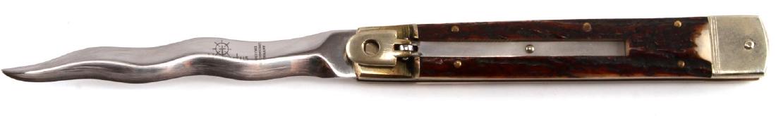 HUBERTUS LARGE KRIS SWITCHBLADE STYLE KNIFE: It has genuine stag handle scales, mirror polished stainless steel spear point blade etched with the Hubertus Solingen Germany logo. Brass liners and handle pins. Nickel silver fluted bolsters and lev