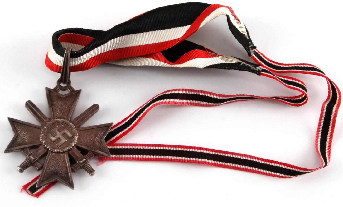 GERMAN WWII KNIGHTS CROSS OF THE WAR MERIT CROSS: German WWII Silver Knights Cross of the War Merit Cross with swords. Only 118 awarded. Features 900 silver mark on base rim. Ribbed suspension loop. Good patina, light wear. With presentation ribbon.