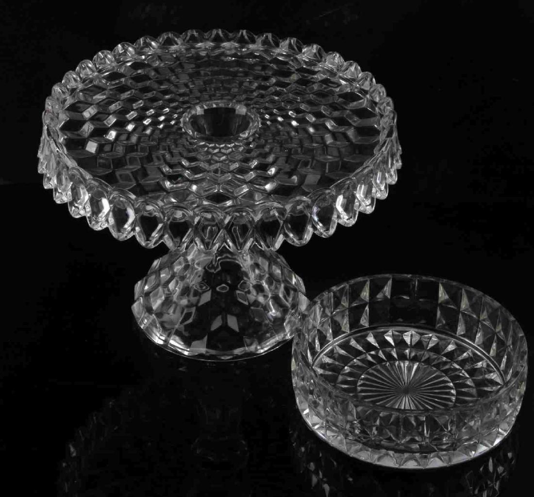 VINTAGE FOSTORIA CRYSTAL GLASS PEDESTAL CAKE PLATE: Fostoria Crystal Glass pedestal cake plate with rum well in the popular “American” pattern. The cake plate measures approximately 7 inches tall with a 10 inch diameter at the top. In good conditio