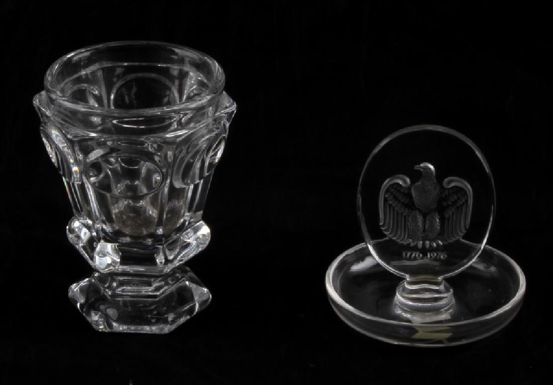 BACCARAT AND LALIQUE BICENTENNIAL FRENCH CRYSTAL: Baccarat measures 12cm in height with a 8cm diameter and is marked on bottom. The Bicentennial ring holder by Lalique is signed on bottom and measures 11cm in height with 10cm diameter. In good condit