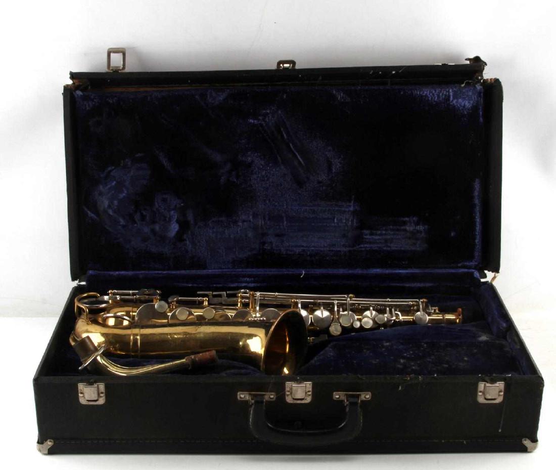 VINTAGE KING CLEVELAND STUDENT SAXOPHONE W CASE: Vintage King Cleveland student saxophone with case. G condition, strong oxidation and tarnishing. Blue interior on case. Measures 11 1/2" x 6 1/2" x 25".