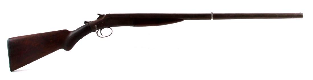 SINGLE SHOT NEW YORK ARMS 12 GAUGE SHOTGUN: Brown oxidized patina, wood stock, thumb release to open 29 3/8 inch barrel, bore is good with light pitting towards muzzle end, maker marked to left side frame, top of barrel is marked "genuine armor