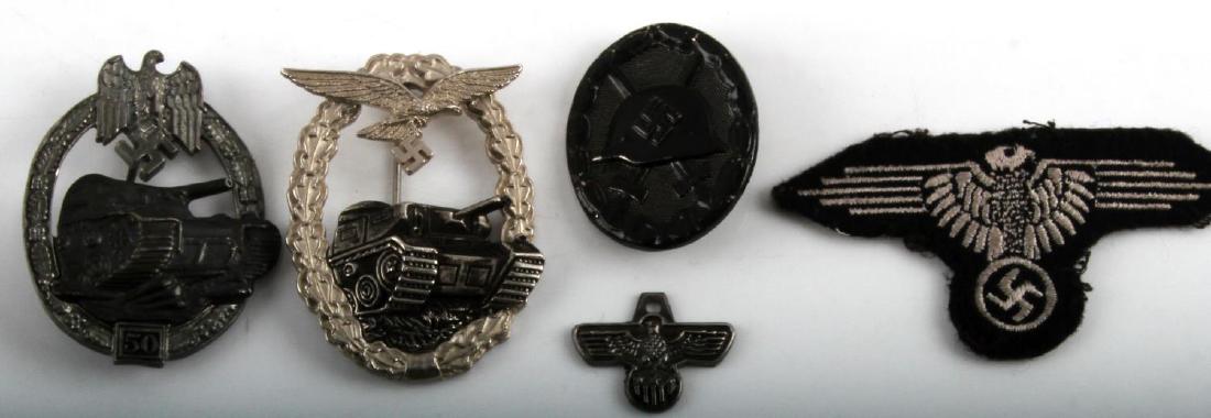 LOT OF 9 MIXED GERMAN WWII PATCHES BADGES MORE: Lot of 9 mixed German WWII items. Includes 3 insignia patches, one small insignia tag, 2 panzer assault badges, and a black wound badge.